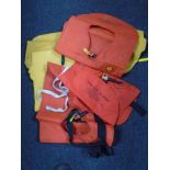 A box containing three self inflating life jackets.