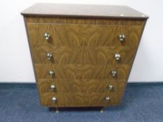 A mid-20th century melamine five drawer chest.