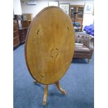 A 19th century inlaid mahogany oval tilt top pedestal tea table.