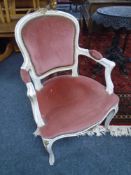 A French white and gilt salon armchair upholstered in pink dralon fabric.