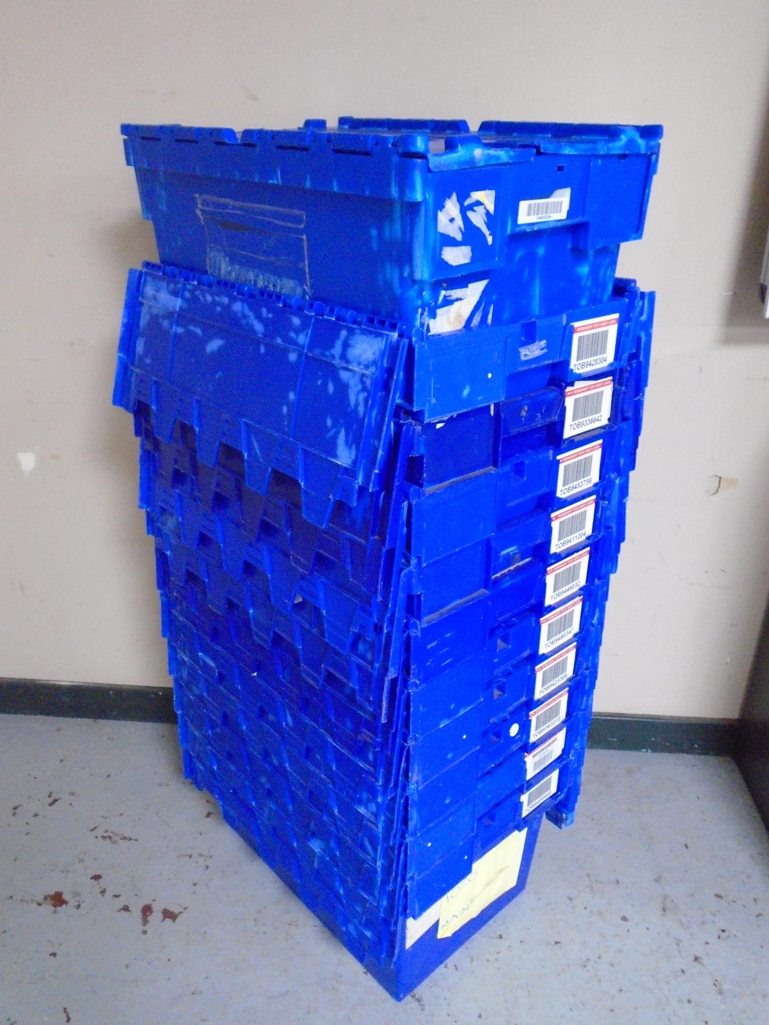 A collection of 12 plastic storage crates with lids.