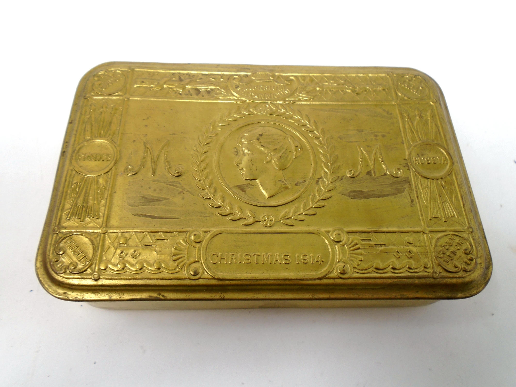 A reproduction 1914 brass Christmas tin.