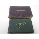 Two early 20th century autograph albums containing hand coloured drawings, watercolours, notations,