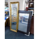 A contemporary bevel edge mirror in brown leather frame and a gilt framed hall mirror.