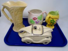 A tray containing a novelty teapot in the form of a racing car, Arthur Wood vase,