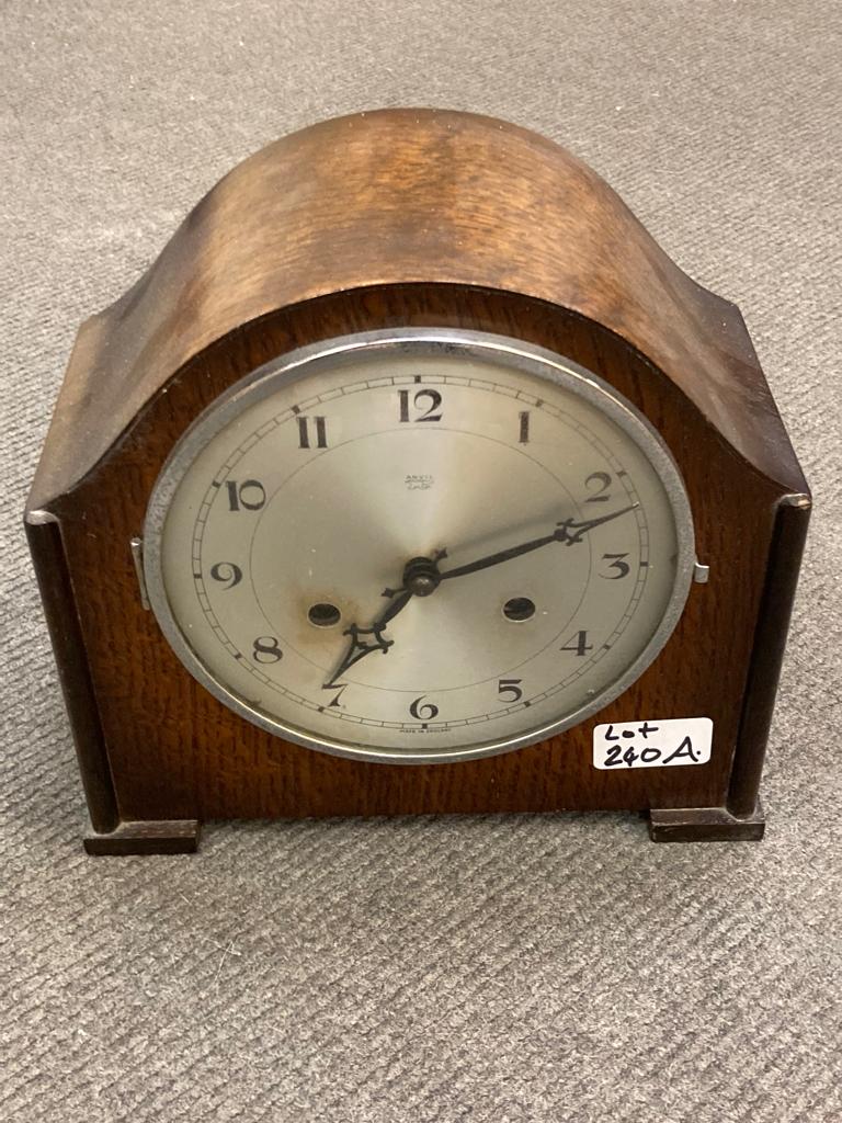 An Anvil oak-cased chiming mantel clock, with key.