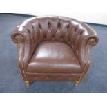An Alexander & James buttoned and studded leather tub armchair.