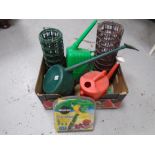 A box containing three plastic watering cans,