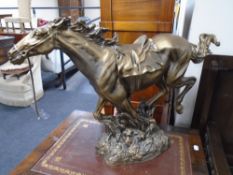 A gilt resin figure of a galloping horse.