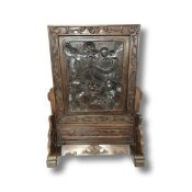 A Chinese hardwood table screen with carved dragon decoration, height 63 cm, width 46 cm.