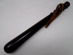 A turned wooden truncheon.
