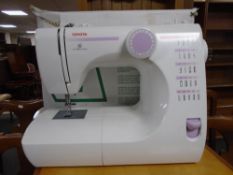 A Toyota electronic control electric sewing machine with cover and foot pedal in original box.