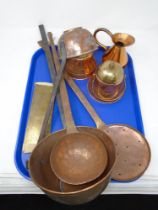 A tray of antique copper and brassware including ladles, jug, roasting pan etc.