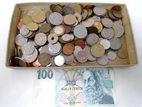 A box containing a quantity of foreign coinage together with a Czechoslovakian banknote.