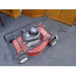 A Briggs and Stratton classic petrol self drive lawn mower.