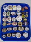 A tray containing a collection of metal and porcelain trinket boxes.