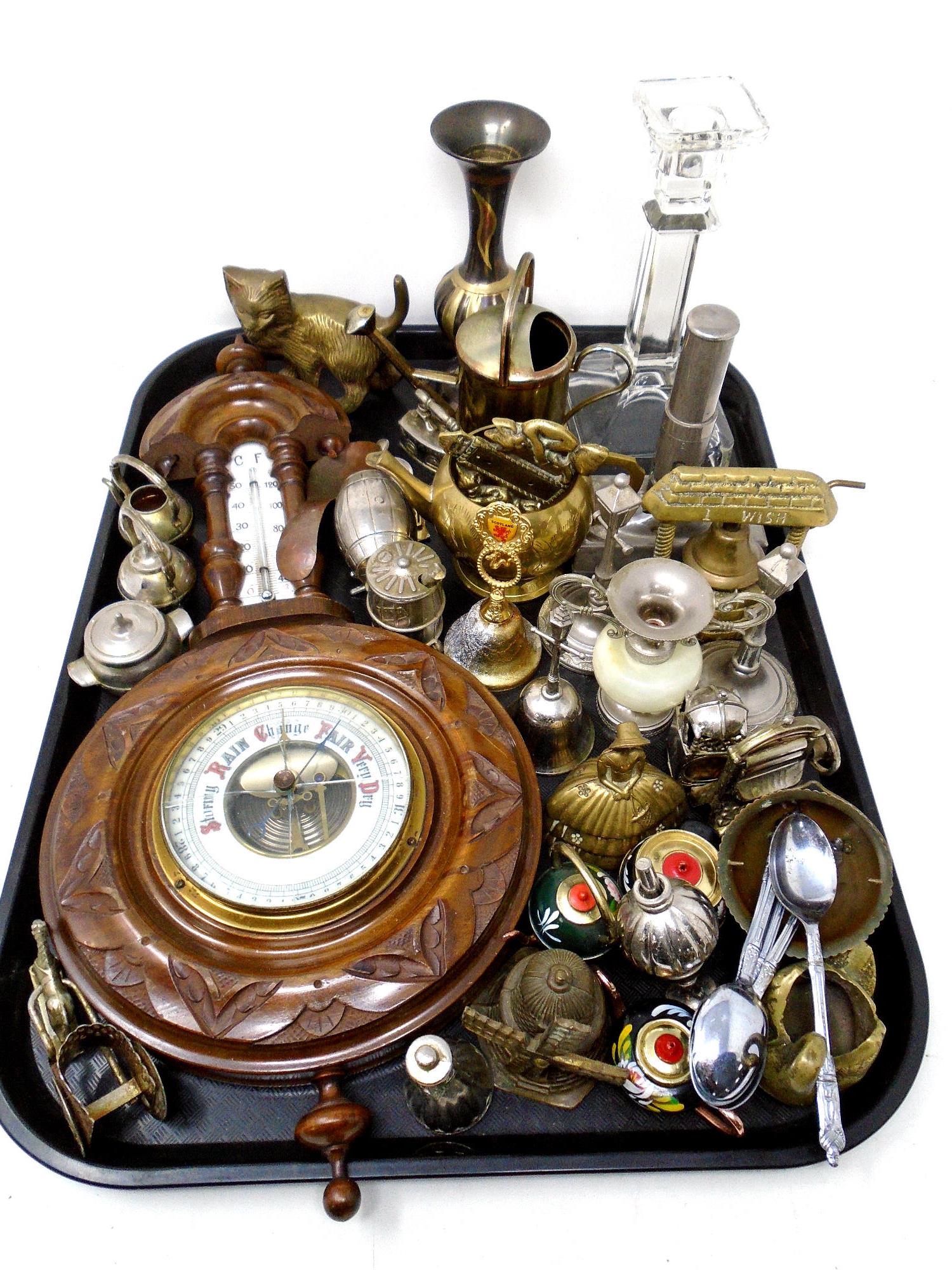 A tray containing a barometer, assorted brass ware, bells, glass candlestick, ornaments etc.