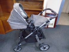 A Silver Cross folding pushchair.