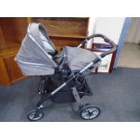 A Silver Cross folding pushchair.