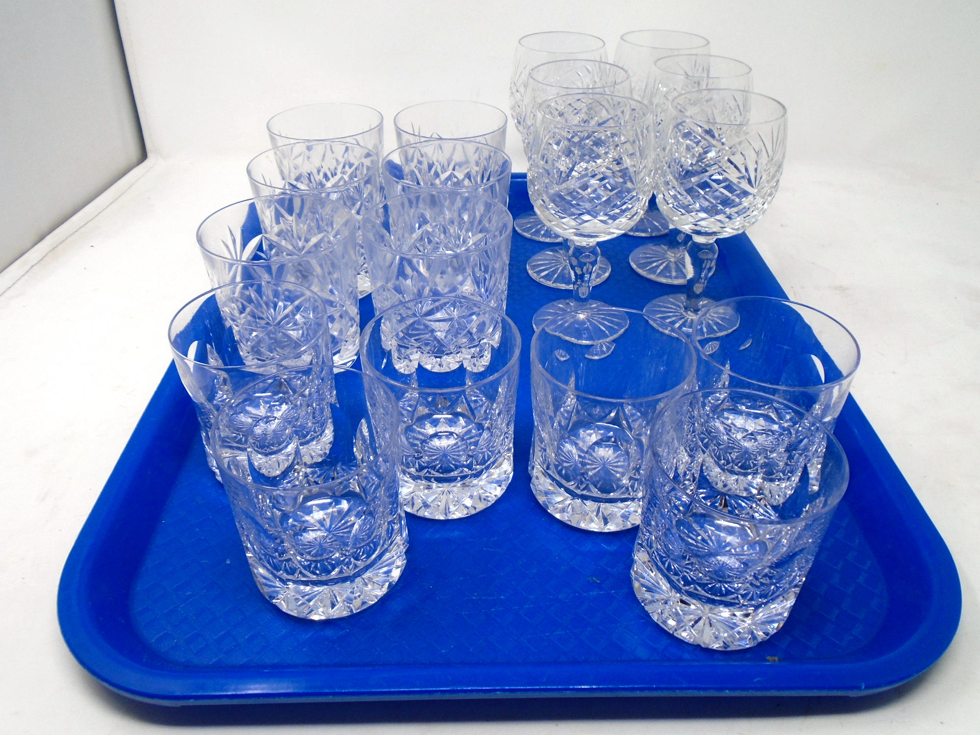 A tray containing assorted glassware including lead crystal, whisky decanters, wine glasses.