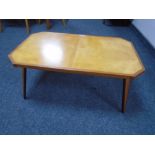 A 20th century plywood octagonal coffee table on tapered legs.