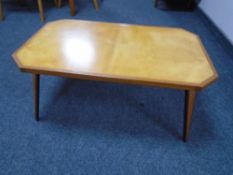 A 20th century plywood octagonal coffee table on tapered legs.