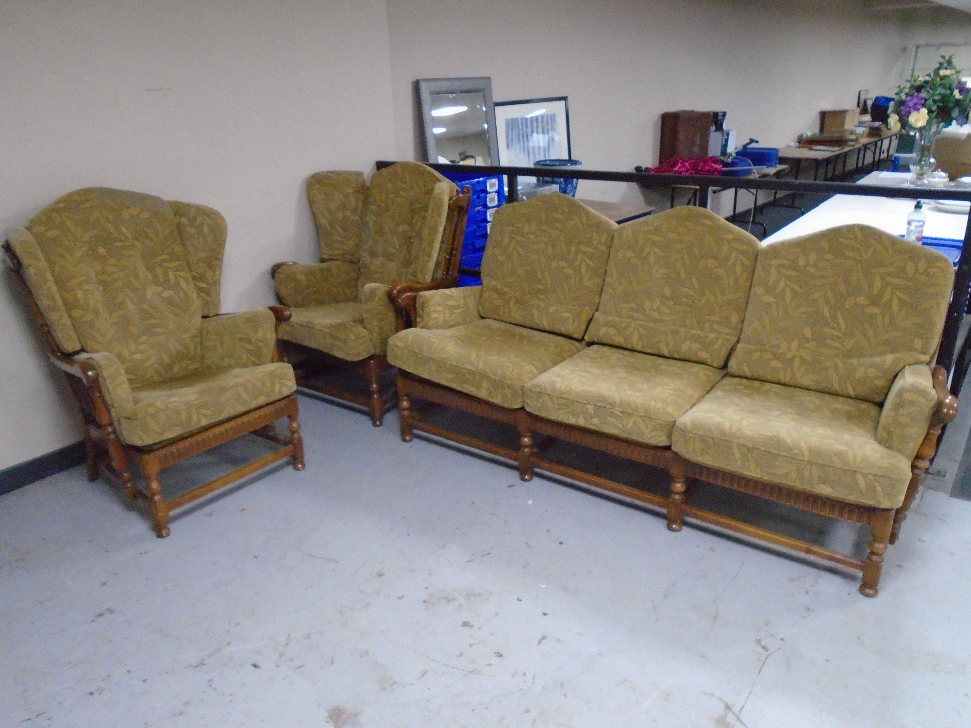 An Ercol elm and beech wood framed three piece lounge suite comprising of a three seater settee and