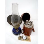 A set of three glass travel flasks in leather carry case together with oil lamp,
