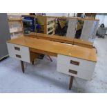 A 1970s two tone kneehole dressing table with triple mirror.