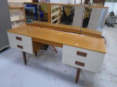 A 1970s two tone kneehole dressing table with triple mirror.