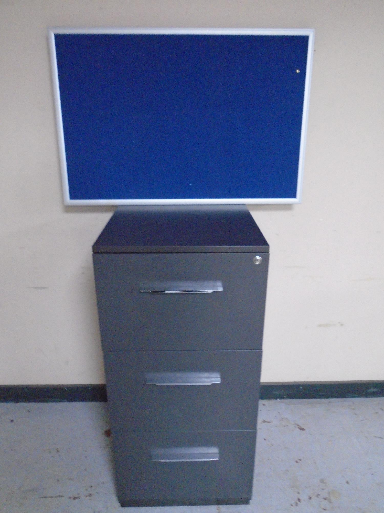 A three drawer filing chest together with three wall mounted notice boards.