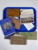 A tray containing souvenir of Malta book, Flowers from the Holy Land, assorted postcards.