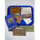 A tray containing souvenir of Malta book, Flowers from the Holy Land, assorted postcards.