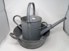 A galvanized twin-handled tub together with a galvanized watering can.
