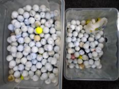 Two boxes containing a large quantity of golf balls.