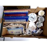 A box containing commemorative items including tea ware, crowns, coronation handkerchief,