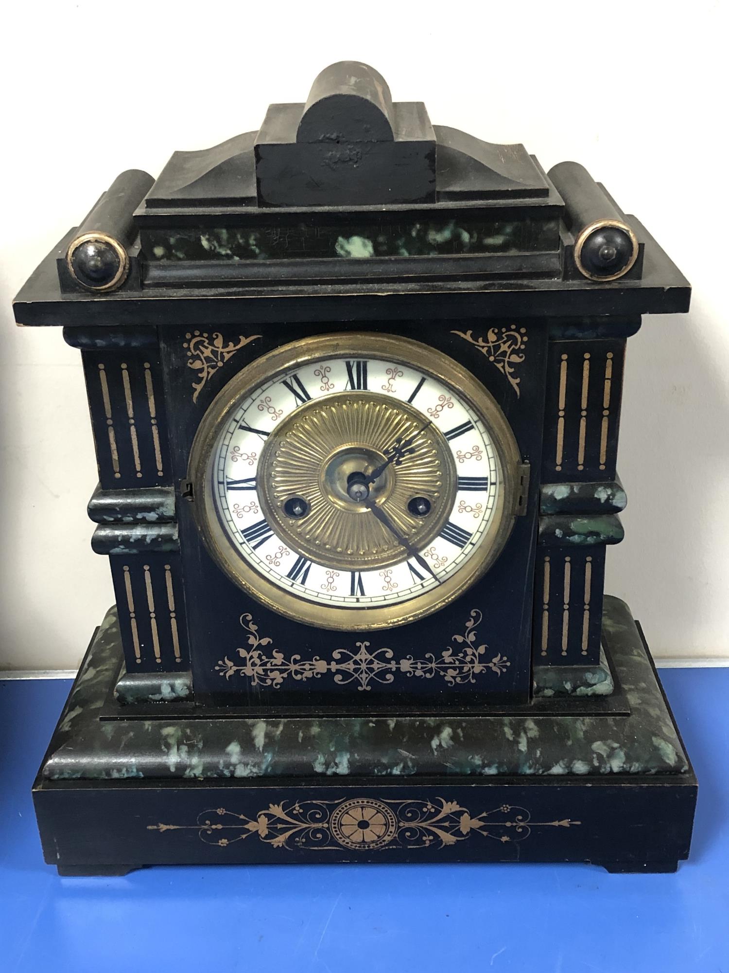 A Victorian marble effect mantel clock.