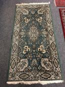 A machined Persian design rug, 92cm by 182cm.