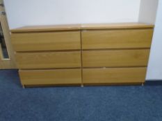 A pair of oak-effect IKEA three drawer chests.