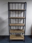 A set of contemporary metal and pine industrial style waterfall bookshelves.