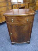 A 19th century mahogany bow-fronted cabinet fitted a drawer
