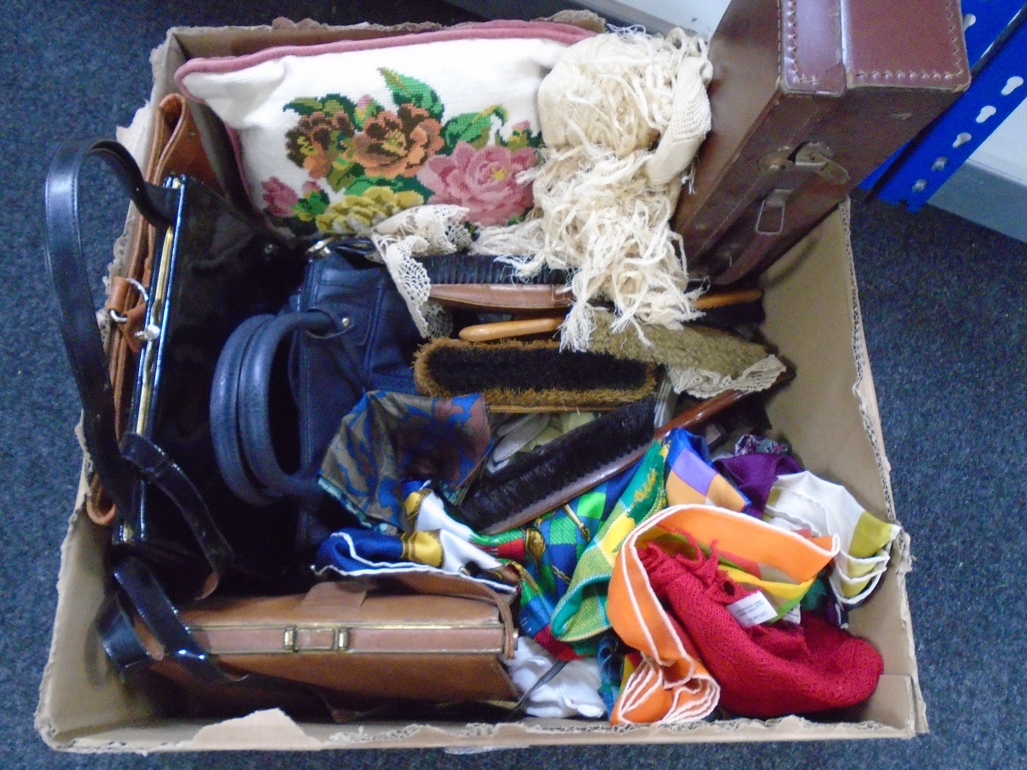 A box of lady's hand bags, embroidered cushion,