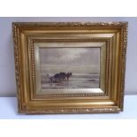 An early 20th century gilt framed oil-on-canvas depicting a figure with a horse and cart,