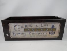 A wooden trough with Clark & Co. sewing cottons advertising (width 44.5cm).