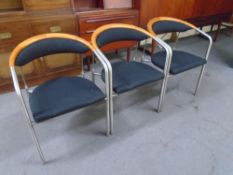 A set of three Hansen & Sorensen tubular metal and fabric armchairs.