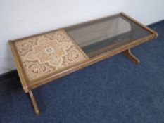 A teak G-plan refectory coffee table with smoked glass inset panel and tiled panel