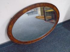 An Edwardian oval walnut framed mirror