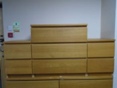 An IKEA three drawer chest together with a pair of matching two drawer bedside chests in an oak