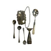 A silver whisky decanter label, three caddy spoons and two further items of cutlery.
