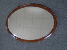 An Edwardian mahogany oval framed mirror